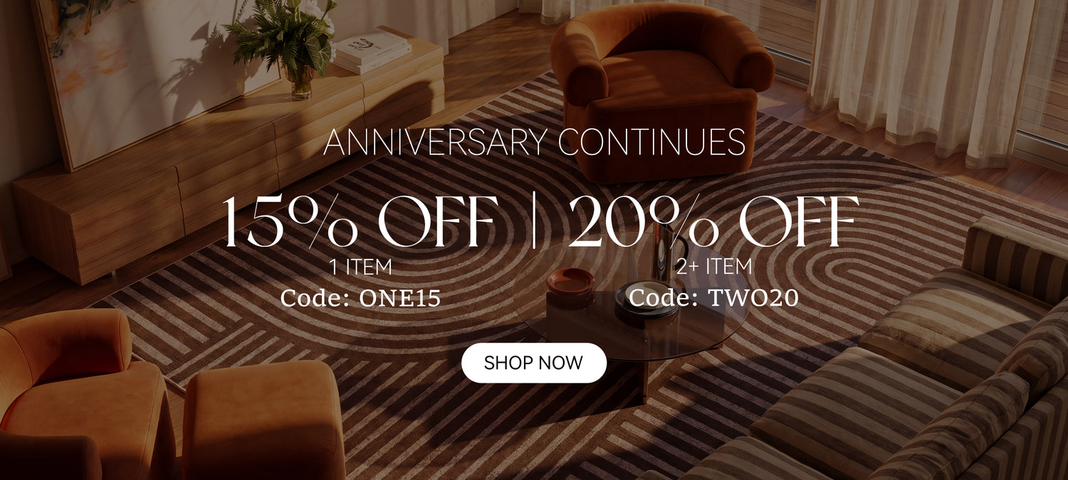 A modern abstract area rug with curved line patterns creates a warm living room backdrop for the MontVooRugs anniversary sale, featuring 15% off one item and 20% off two or more items.