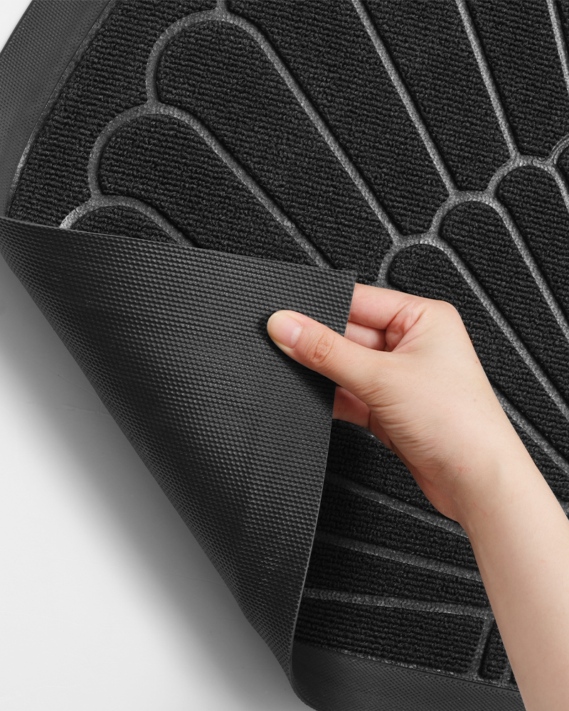 Durable half circle outdoor entry mat with molded rubber edges.