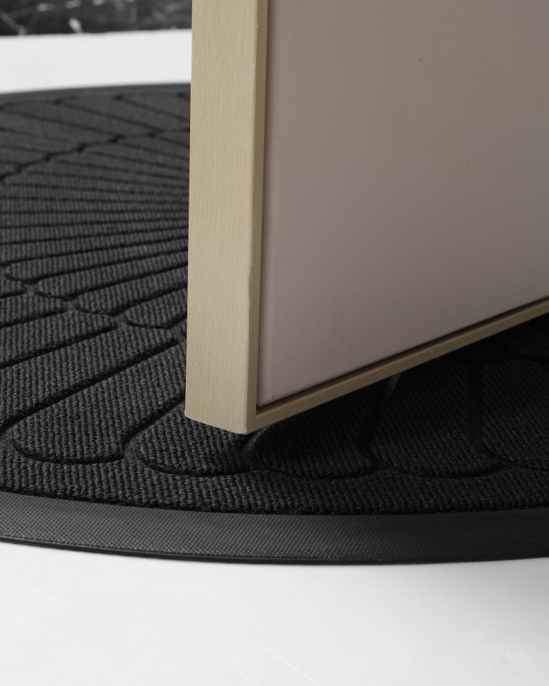 Absorbent half round door rug suitable for both indoor and outdoor use.