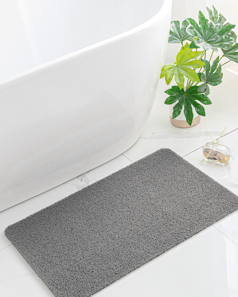 Shower bath mat with PVC loofah surface, non-slip and gentle on bare feet.