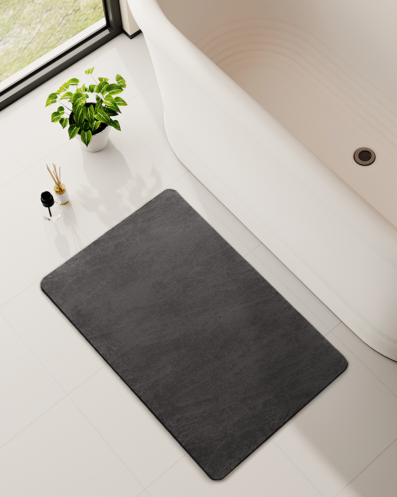 Machine washable bath mat with faux suede surface, easy to clean and maintain.