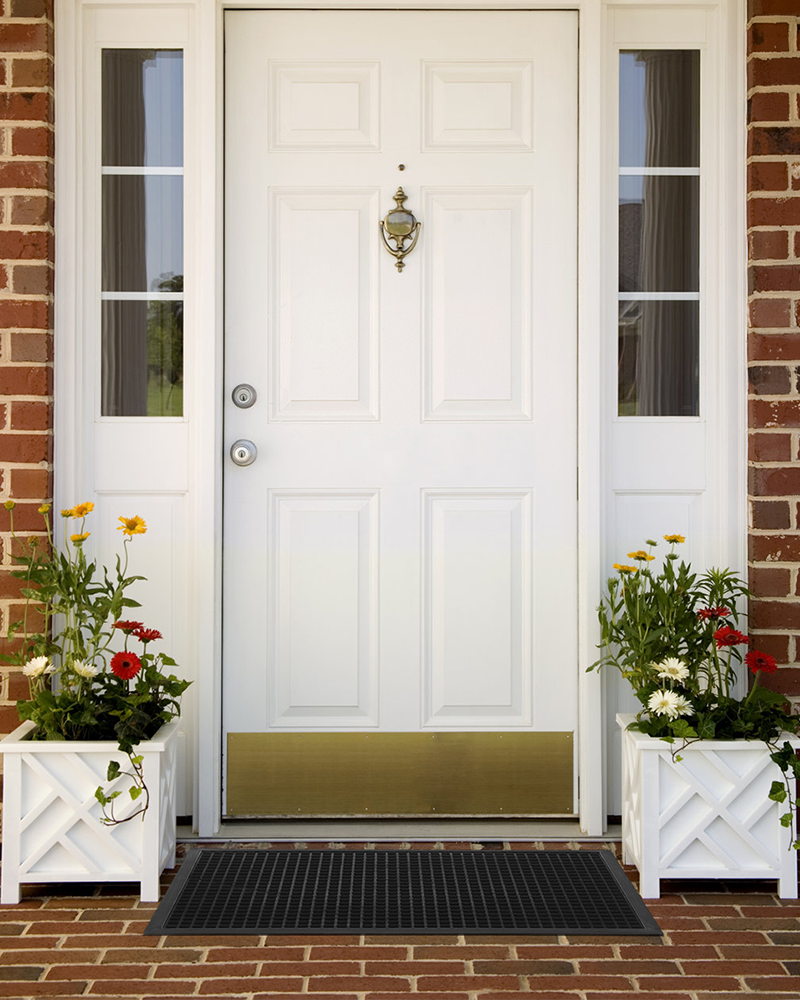 Waterproof entry mat with rubber backing traps dirt, mud, and moisture.