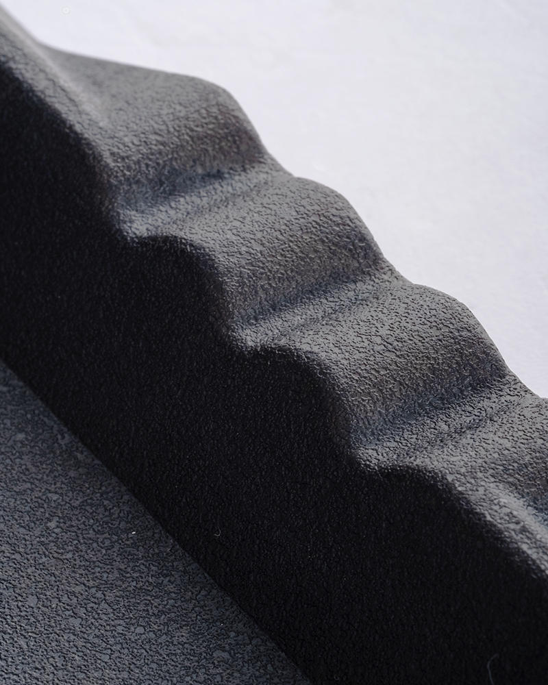 Entryway rubber shoe mat with raised edges to contain mud and water.