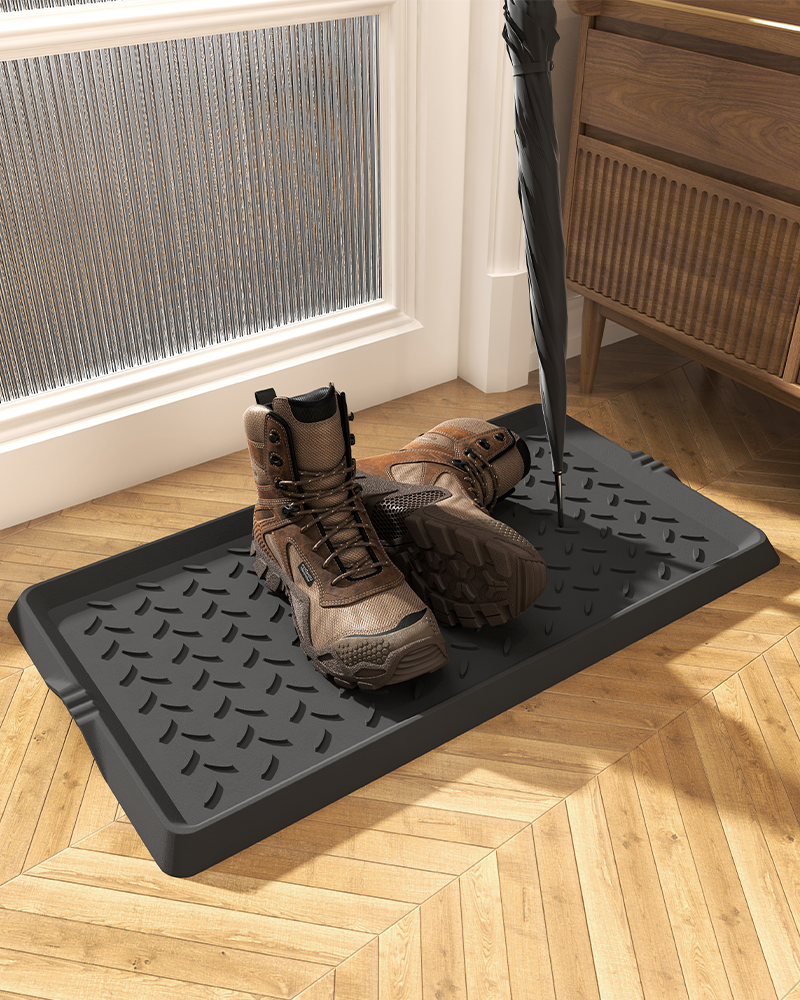 Heavy-duty rubber mat with raised edge to prevent spills in entryway.