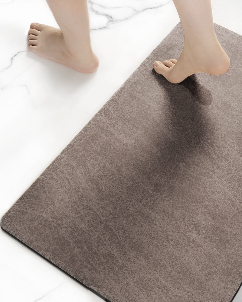 Thin bathroom rug fits under door, absorbent and durable faux suede surface for modern bathrooms.