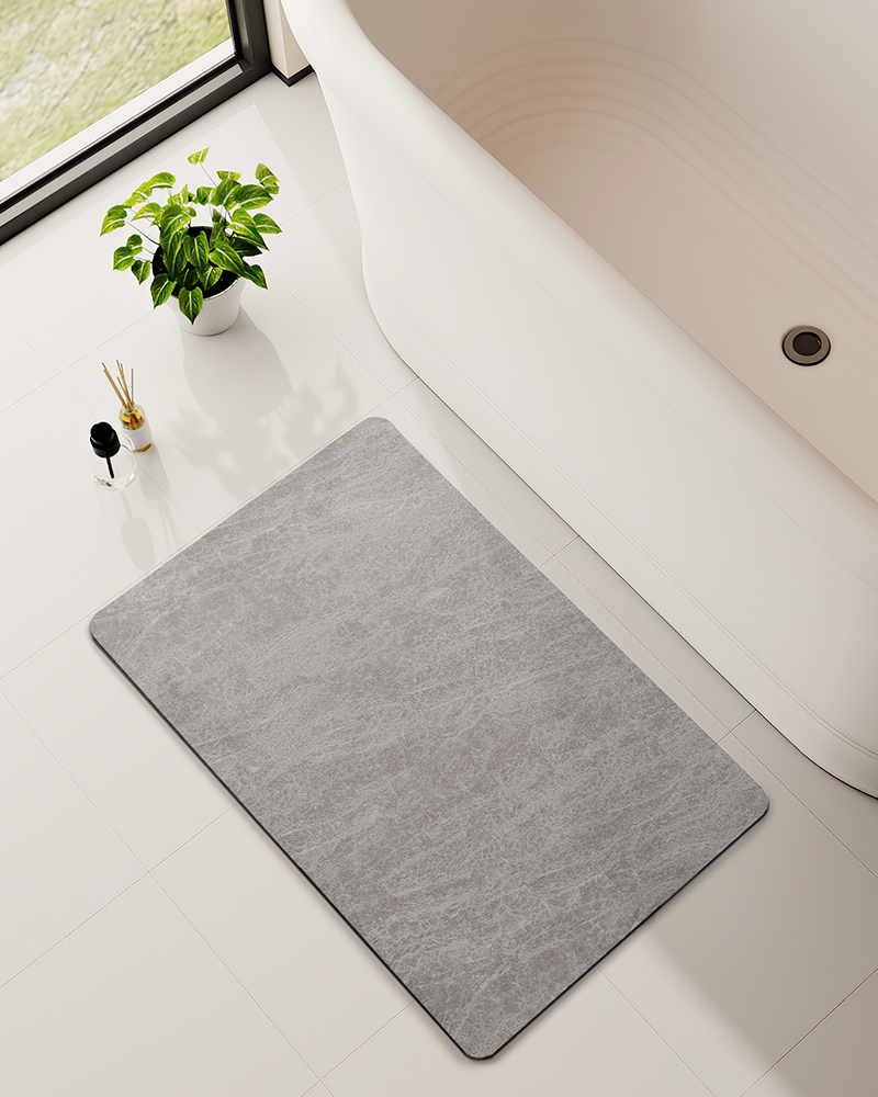 Absorbent thin bath mat with ultra slim profile that dries quickly, fits under doors, and keeps modern bathrooms clean and clutter free