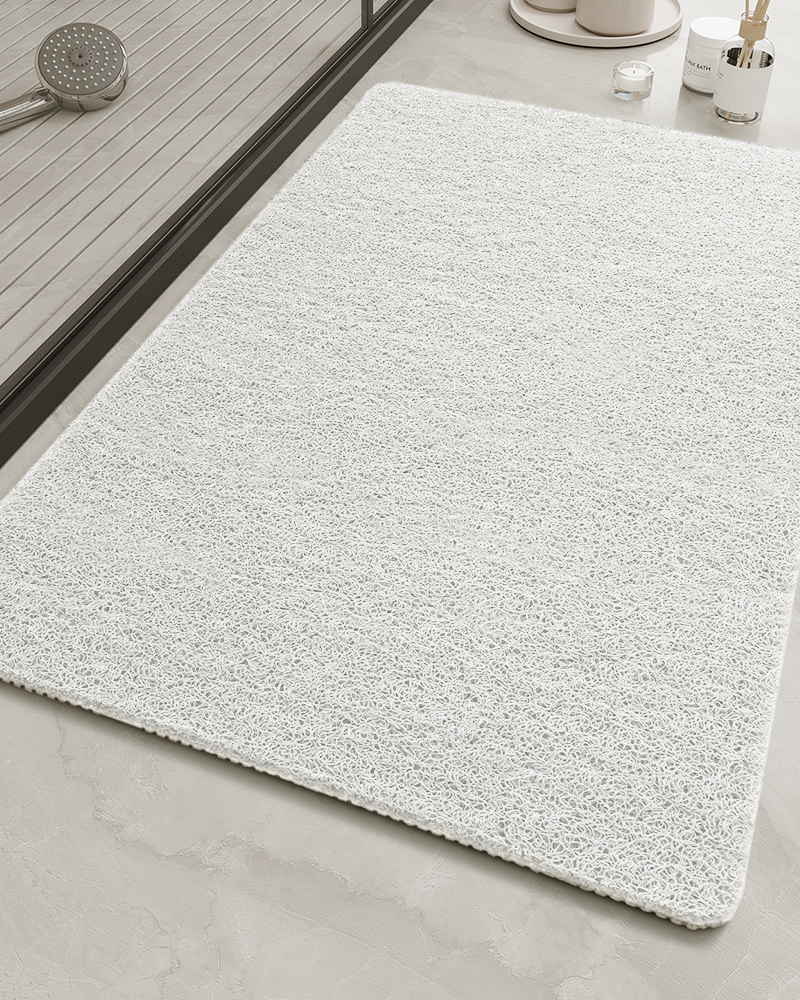 Bath mat that helps prevent puddles and moisture buildup in showers