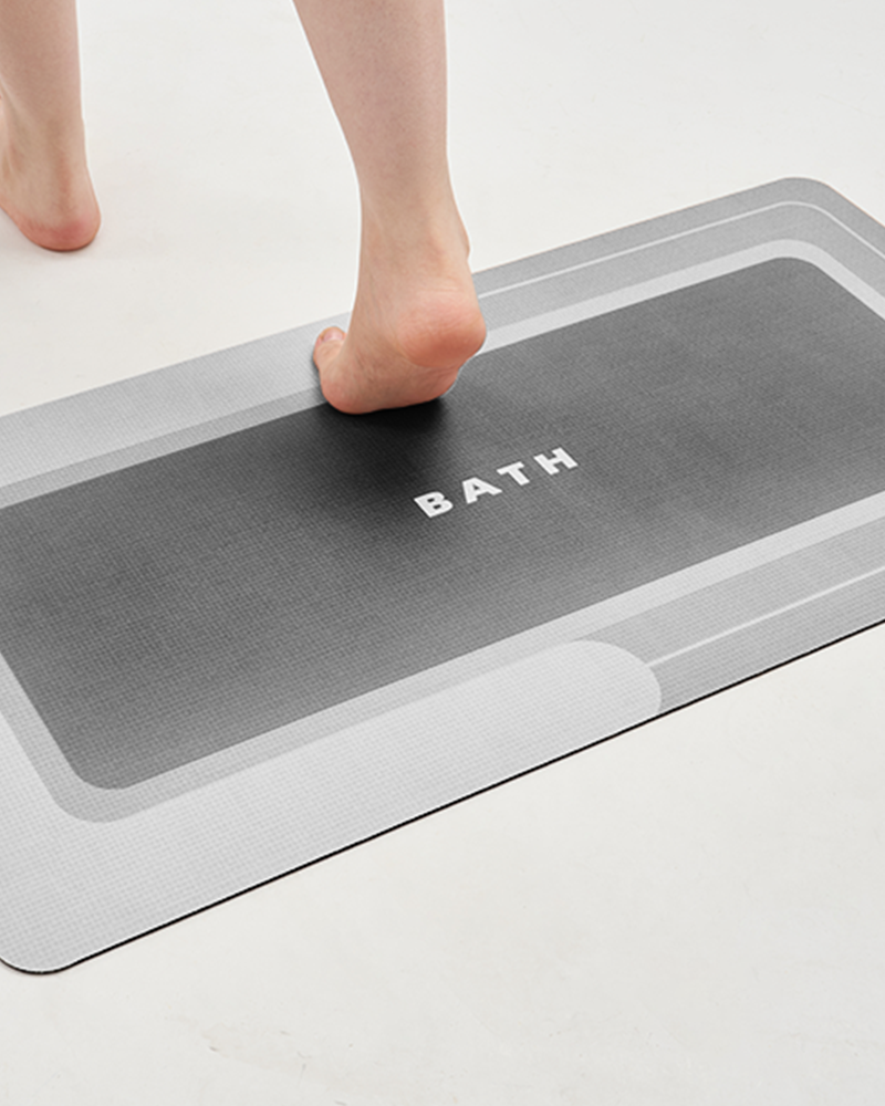 Bath mat with ultra thin profile that fits conveniently under doors and adapts to space constraints