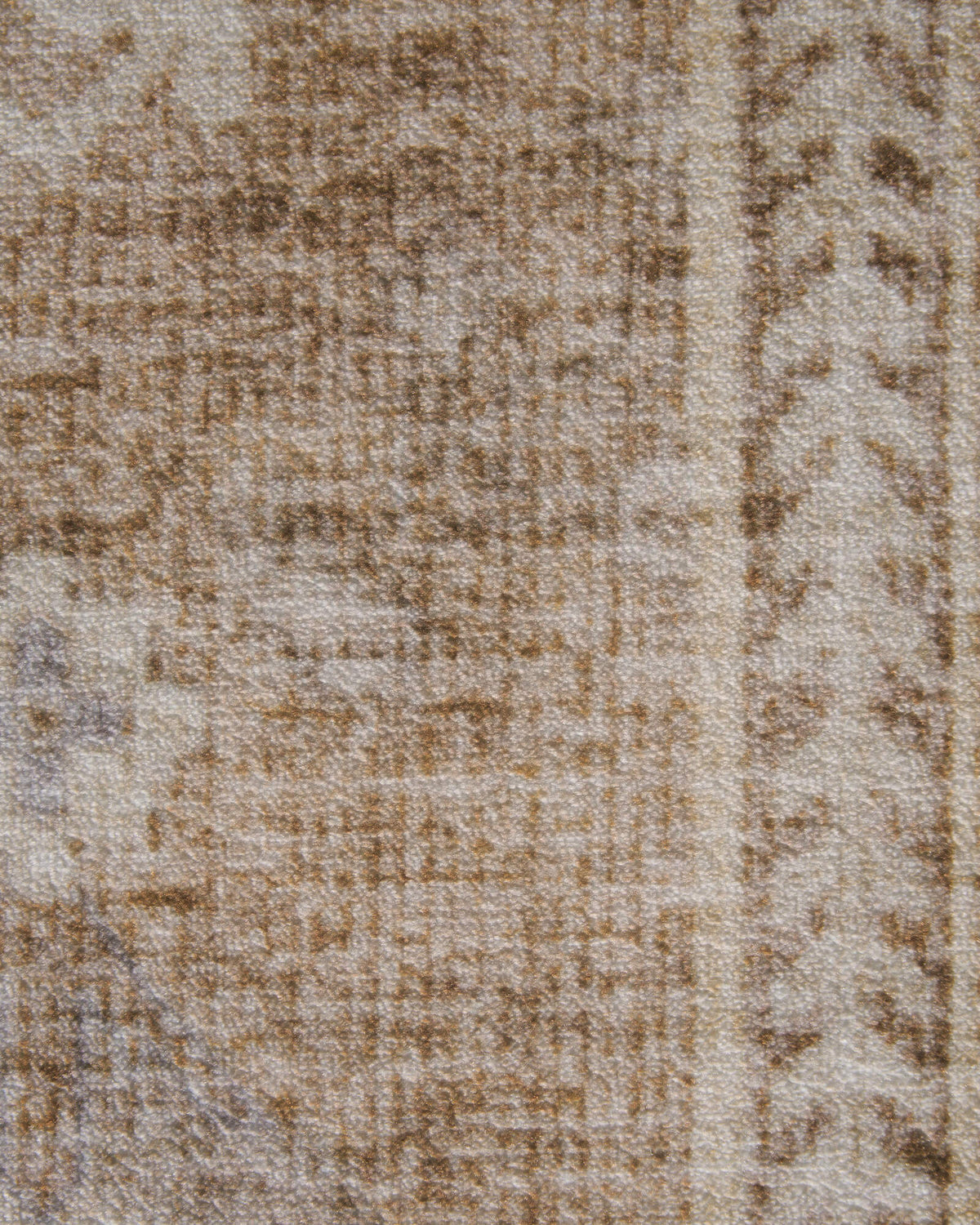 A close-up view of a beige vintage washable area rug highlights its softly faded floral motifs, distressed texture, and subtle beige, warm brown, and gray tones, bringing timeless character to traditional and modern living spaces.