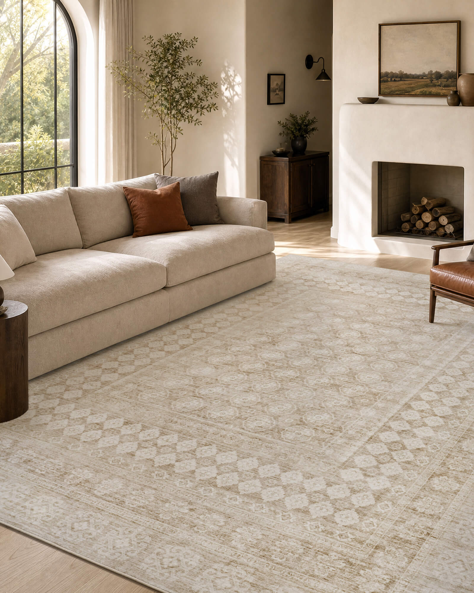 A beige vintage washable area rug adds soft distressed texture and timeless easy-care style to a cozy living room with neutral seating, warm sunlight, and classic home decor.