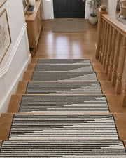 Black and white striped non-slip stair treads line a wooden staircase leading to a welcoming entryway, featuring a textured ribbed surface, neatly bound edges, and a modern linear pattern that provides secure footing, protects hardwood steps, and adds timeless style to everyday home interiors.