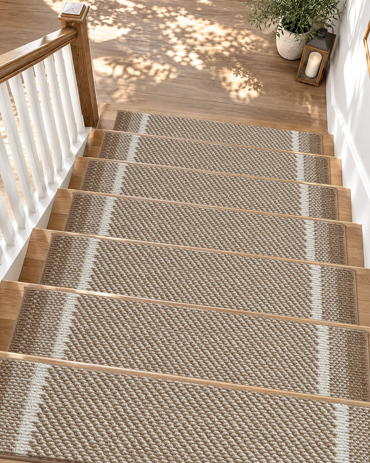 Brown gradient striped non-slip stair treads add warm, modern style to a sunlit wooden staircase, featuring a soft raised diagonal woven texture, contrasting white accent stripes, and neatly bound edges. Their anti-slip backing provides secure footing and helps protect hardwood steps, while the cushioned surface offers everyday comfort for families with kids and pets.