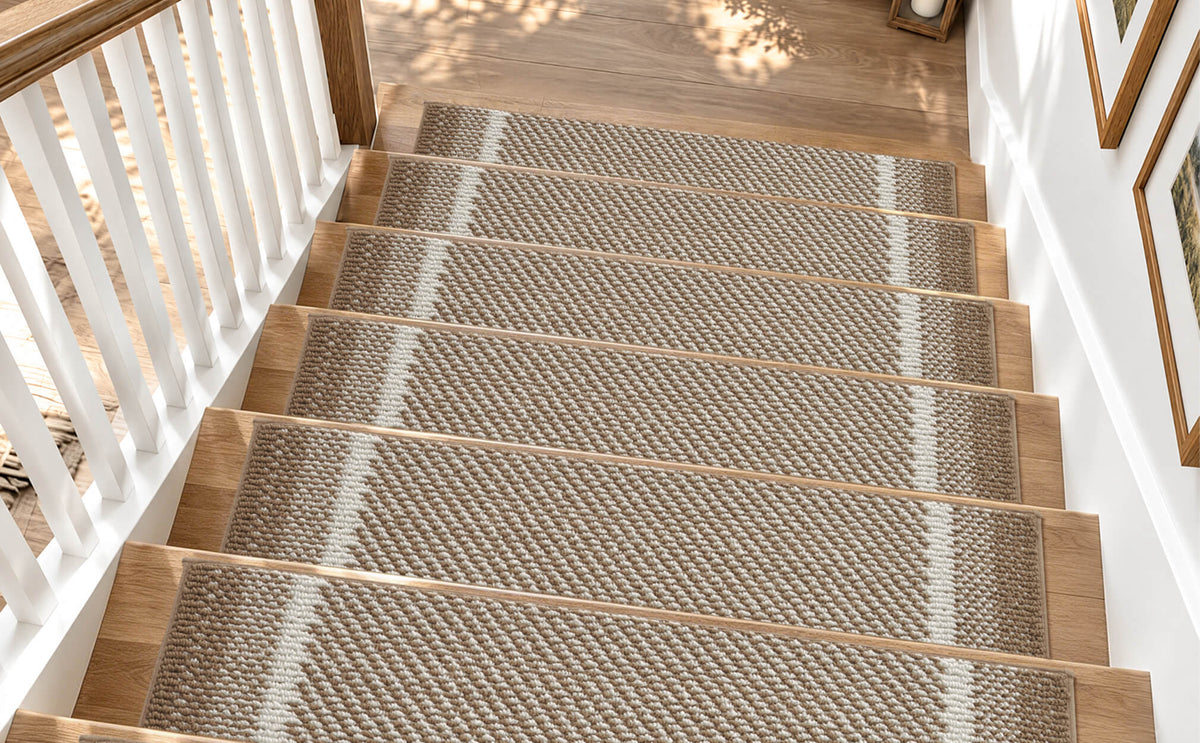 Brown gradient striped non-slip stair treads neatly line a sunlit wooden staircase, featuring a soft raised diagonal woven texture, contrasting white accent stripes, and neatly bound edges. Their anti-slip backing provides secure footing and helps protect hardwood steps while adding warm, modern style and everyday comfort to family-friendly home interiors.