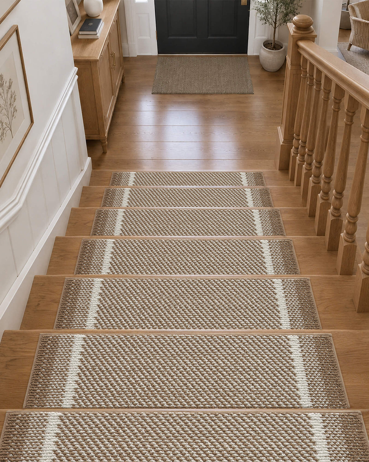 Brown gradient striped non-slip stair treads neatly line a wooden staircase leading to a welcoming entryway, featuring a soft raised diagonal woven texture, contrasting white accent stripes, and neatly bound edges that provide comfortable footing, help protect hardwood steps, and add warm, modern style to everyday home interiors.