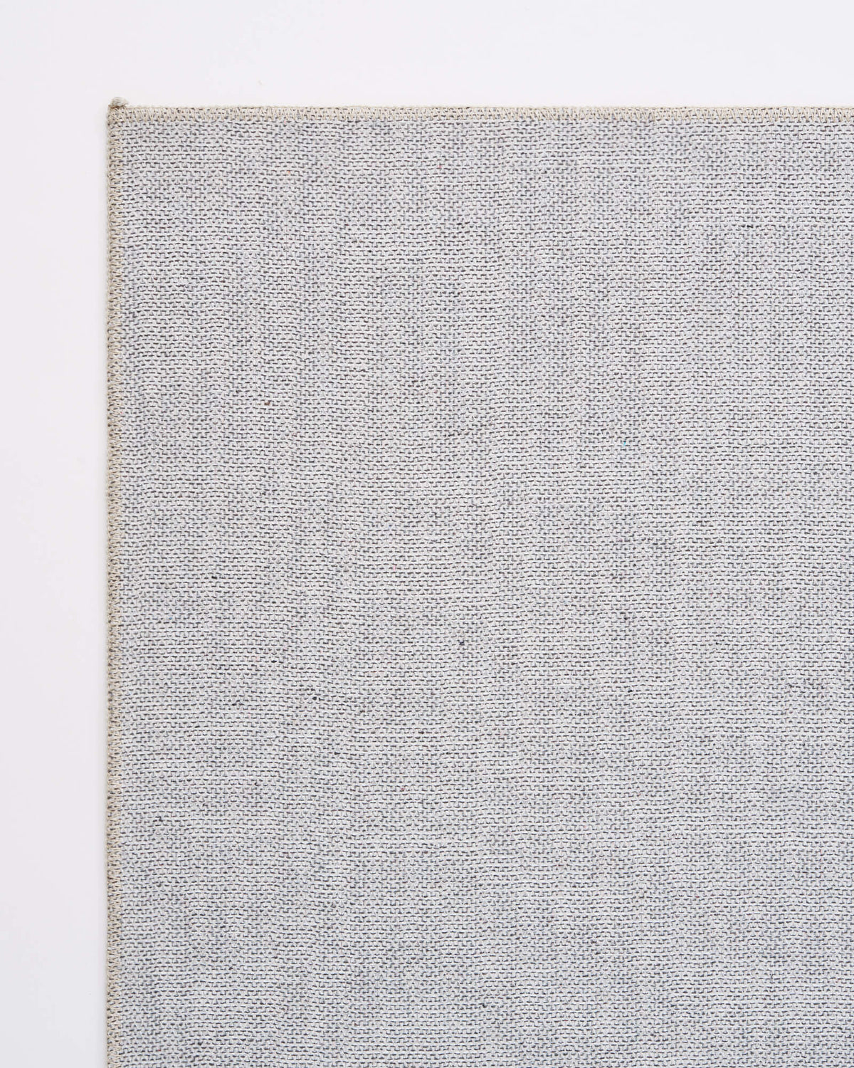 A close-up reverse corner view of a brown vintage washable area rug highlights its gray non-slip backing, neatly finished edge, and durable easy-care construction for living rooms, bedrooms, and busy family homes.