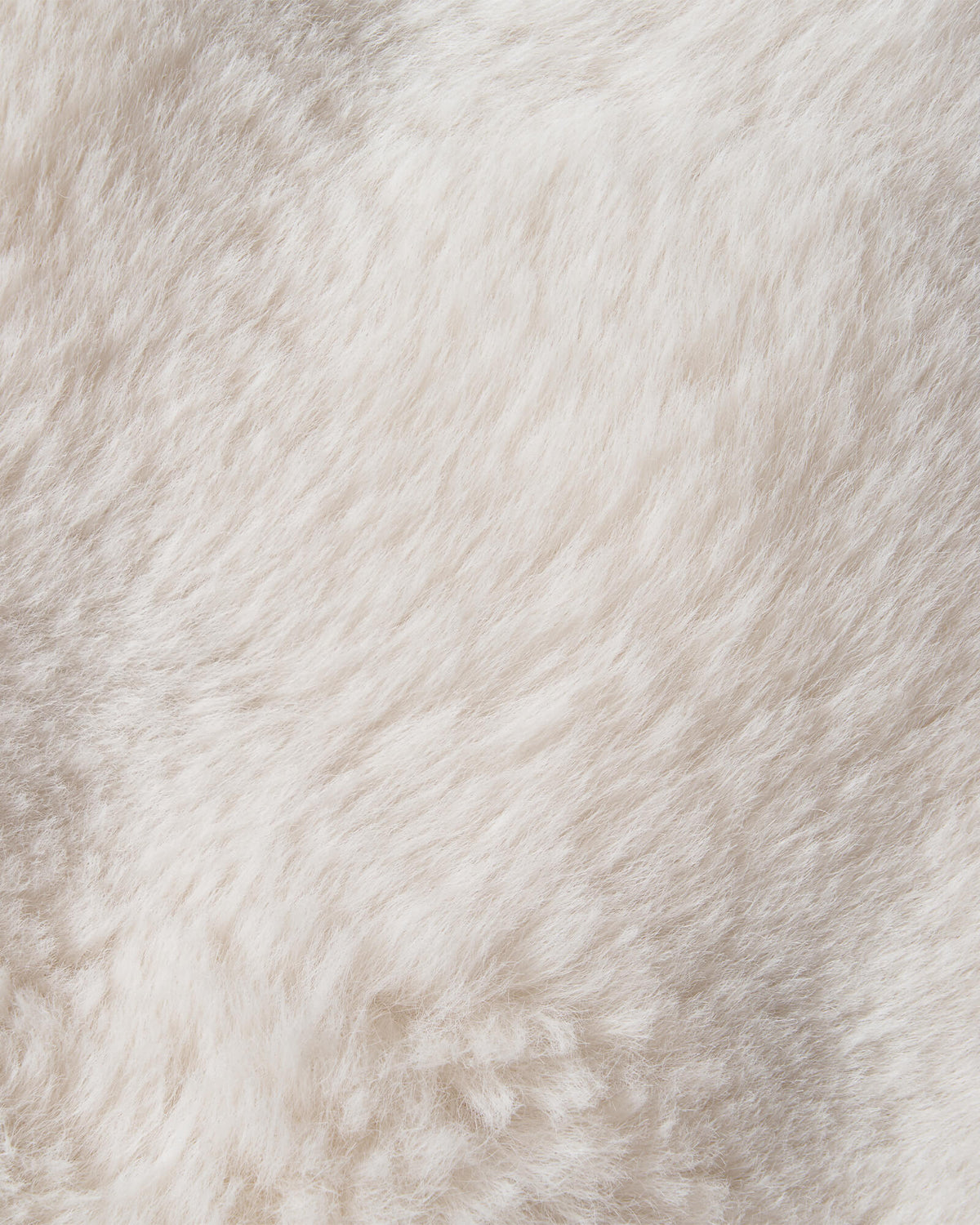 An extreme close-up of a cream Cloud Soft shag area rug highlights its silky faux-fur-like fibers, ultra-fluffy long-pile texture, and luxurious cloud-like softness, creating an irresistibly cozy feel for barefoot comfort in bedrooms, living rooms, and relaxing home spaces.