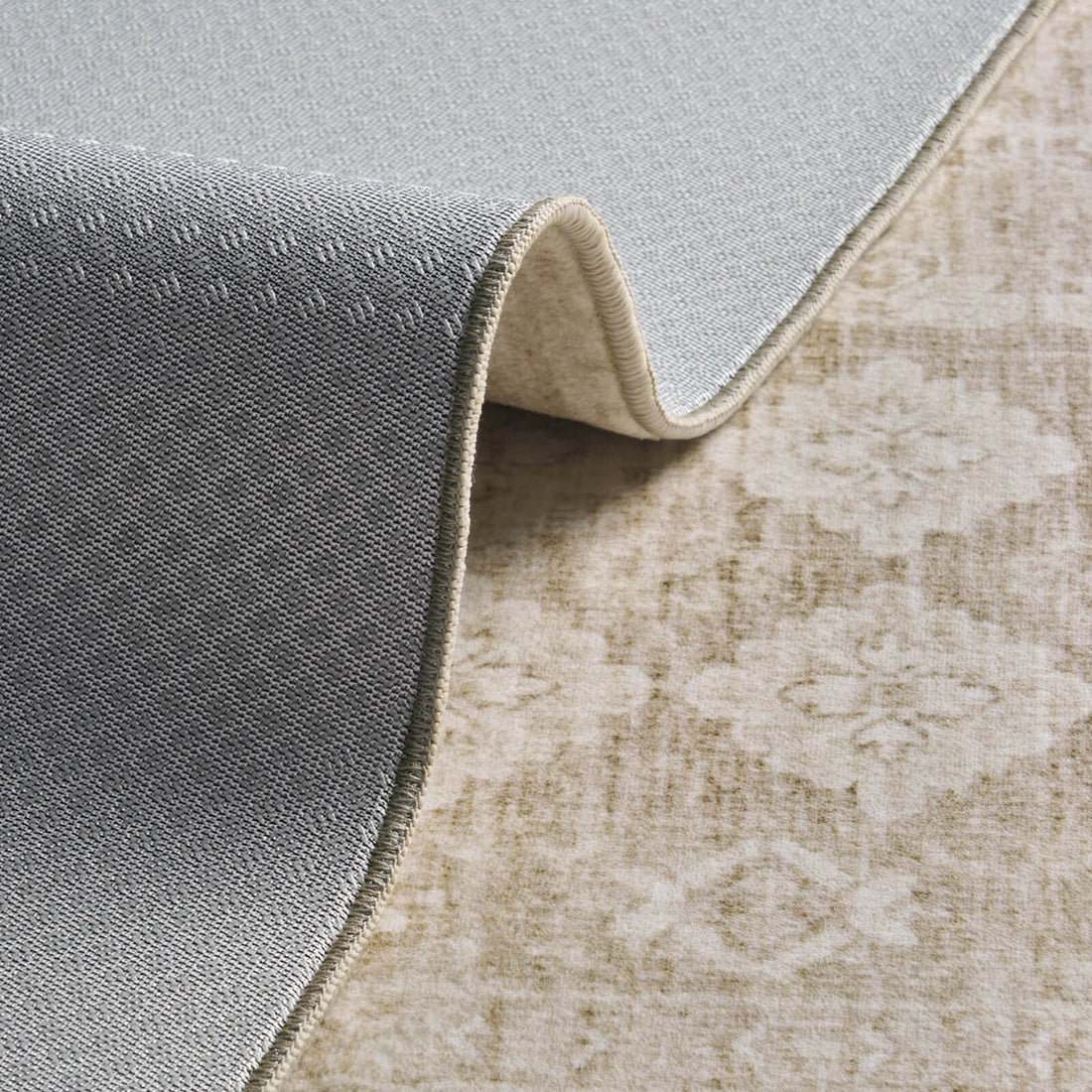 A foldable beige vintage washable area rug features a soft distressed surface and flexible backing, making it easy to move, clean, and style in cozy living rooms, bedrooms, and busy homes.