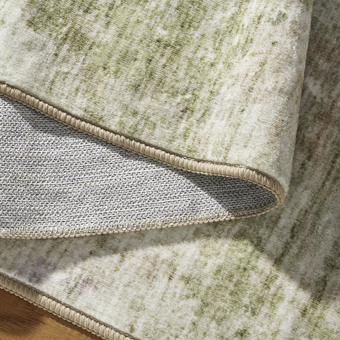 A foldable green washable area rug features a soft modern surface, reinforced edges, and non-slip backing for easy storage and everyday home use.