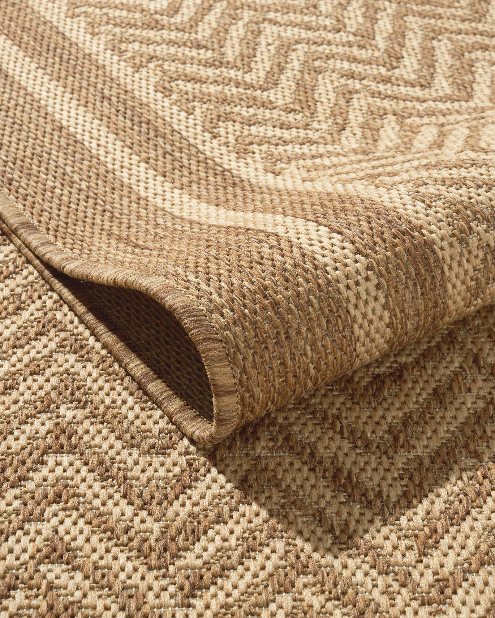 A foldable natural chevron indoor outdoor rug features a durable woven texture, raised geometric pattern, and reinforced edge for easy-care use on patios, porches, dining areas, and high-traffic spaces.
