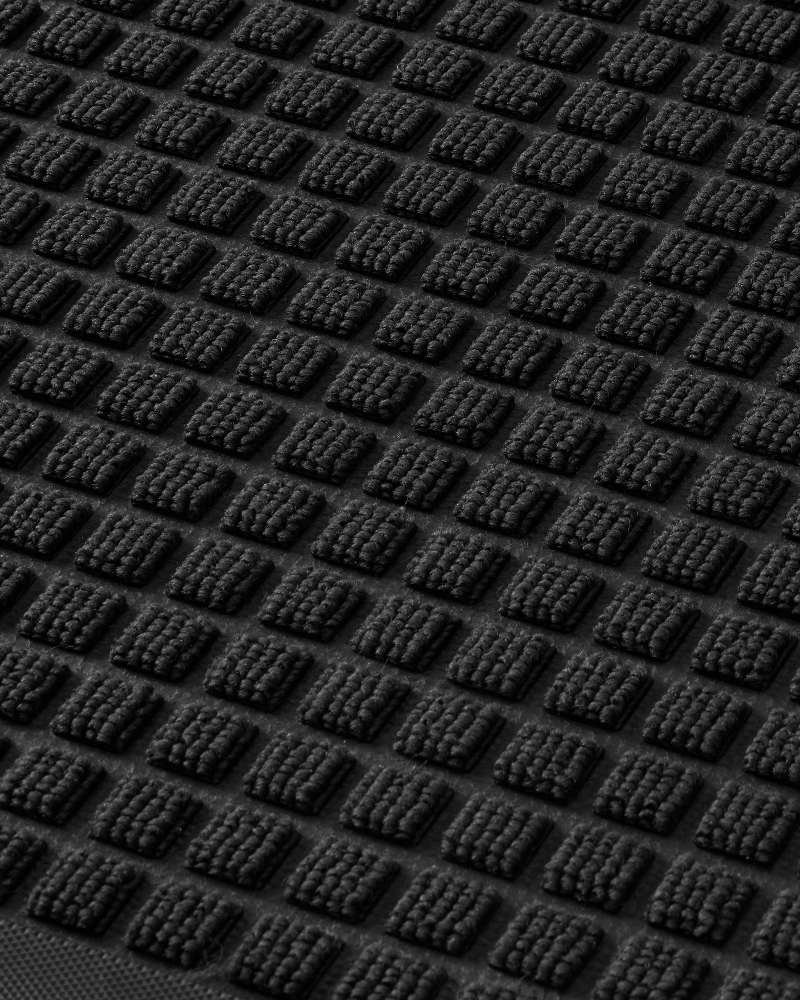 Low-profile washable door mat for entryway, non-slip and easy to clean.