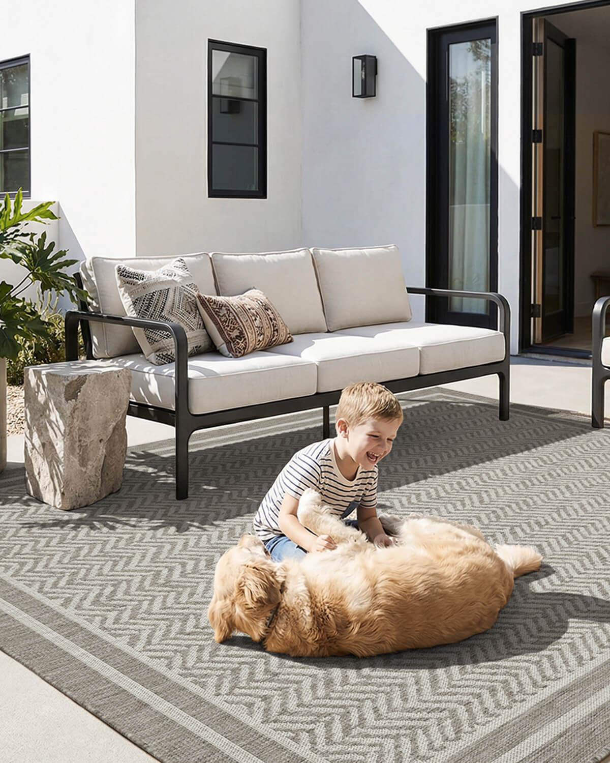 Faux jute indoor outdoor rug featuring an elegant scroll pattern and warm woven texture