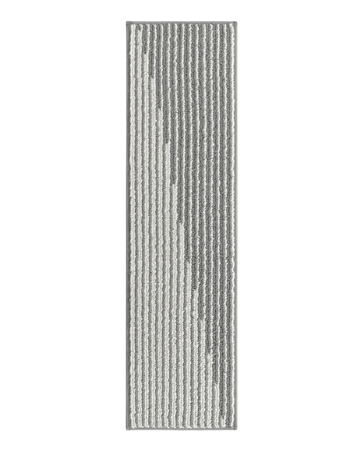 A gray and white striped woven stair tread mat features a modern linear pattern, soft raised ribbed texture, and neatly bound edges, offering comfortable footing, non-slip protection, and understated style for indoor wooden staircases.