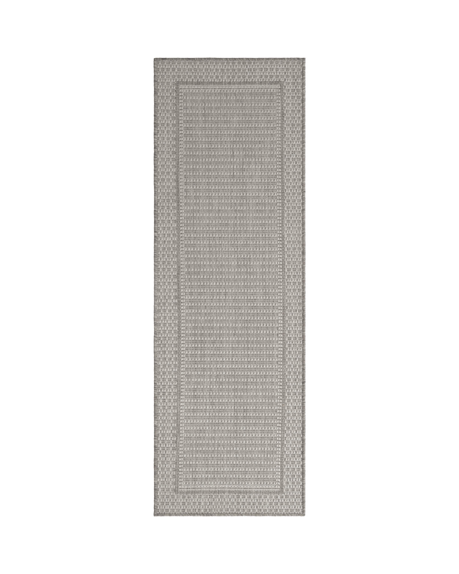 A gray woven indoor outdoor runner rug features a durable jute-look texture and subtle border design, adding easy-care style to hallways, kitchens, patios, porches, and high-traffic spaces.