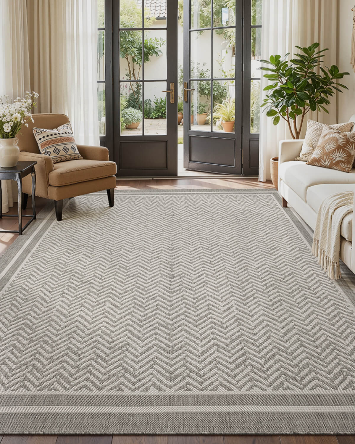 Indoor outdoor rug with natural woven look and elegant scroll border design