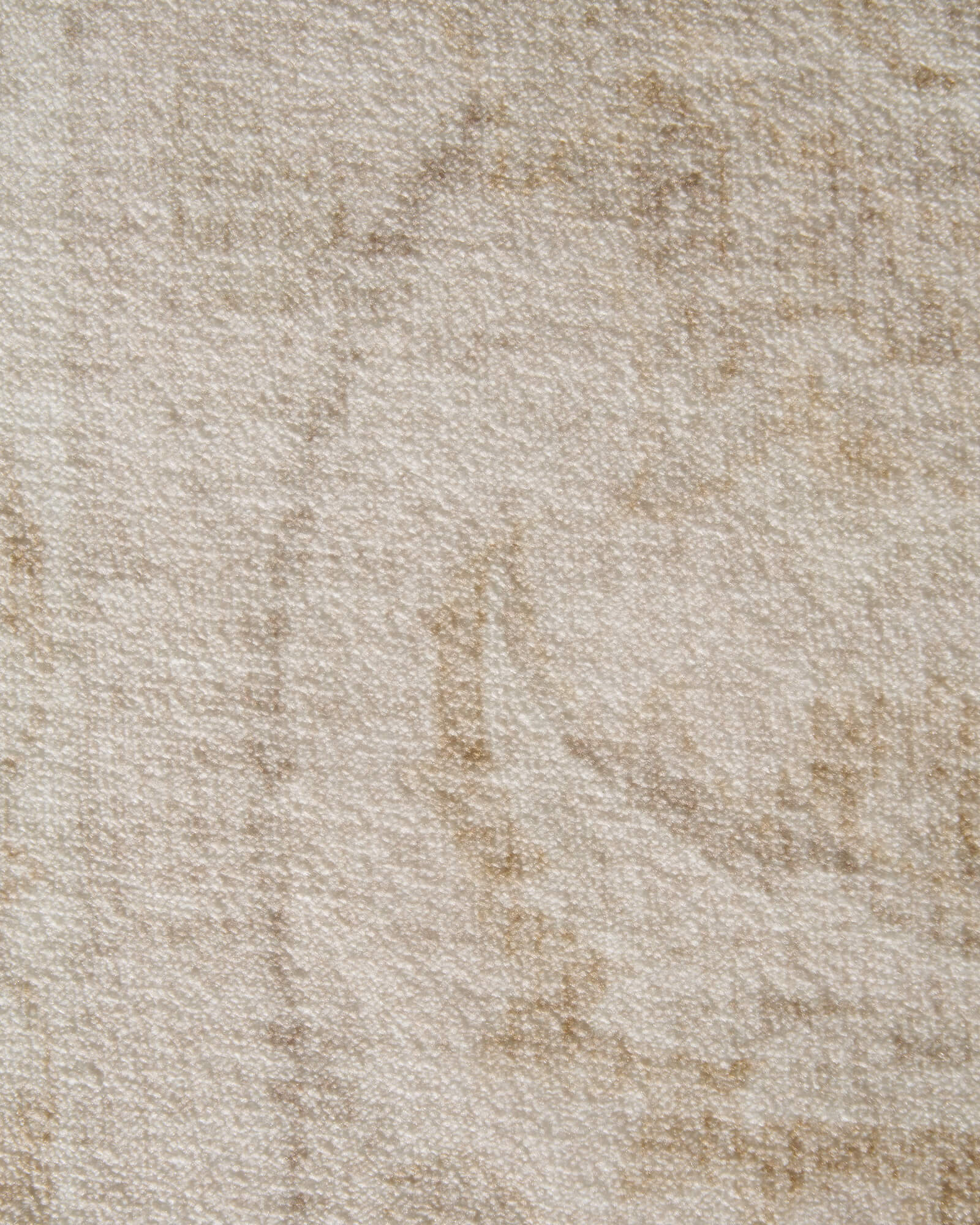 A close-up view of an ivory beige vintage washable rug highlights its mottled distressed texture, soft low-pile surface, and subtle neutral tones for cozy living rooms, bedrooms, and everyday home decor.