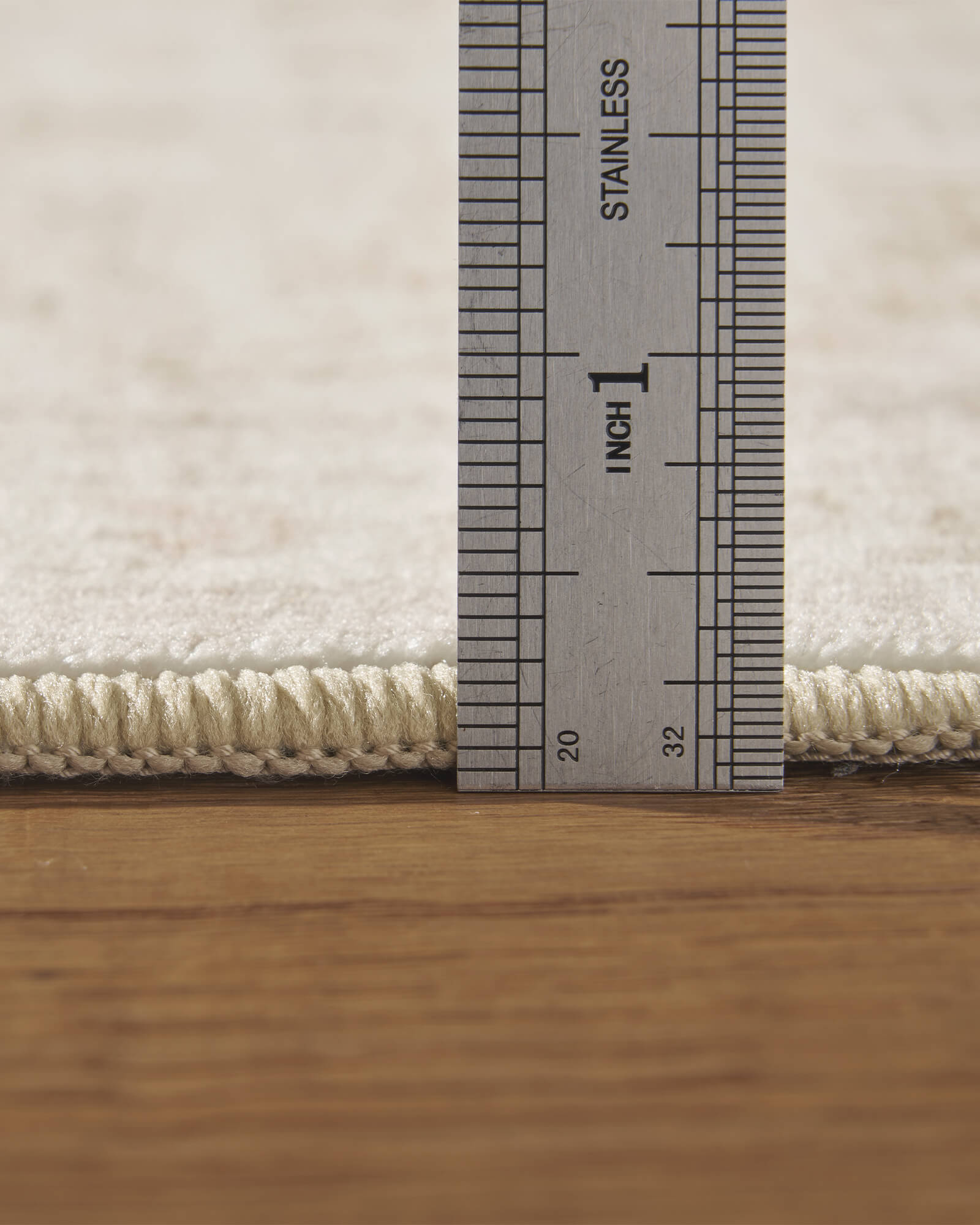 A close-up view of an ivory beige vintage washable rug showing its low-pile thickness, soft surface, and finished edge for easy everyday use in living rooms, bedrooms, and family homes.