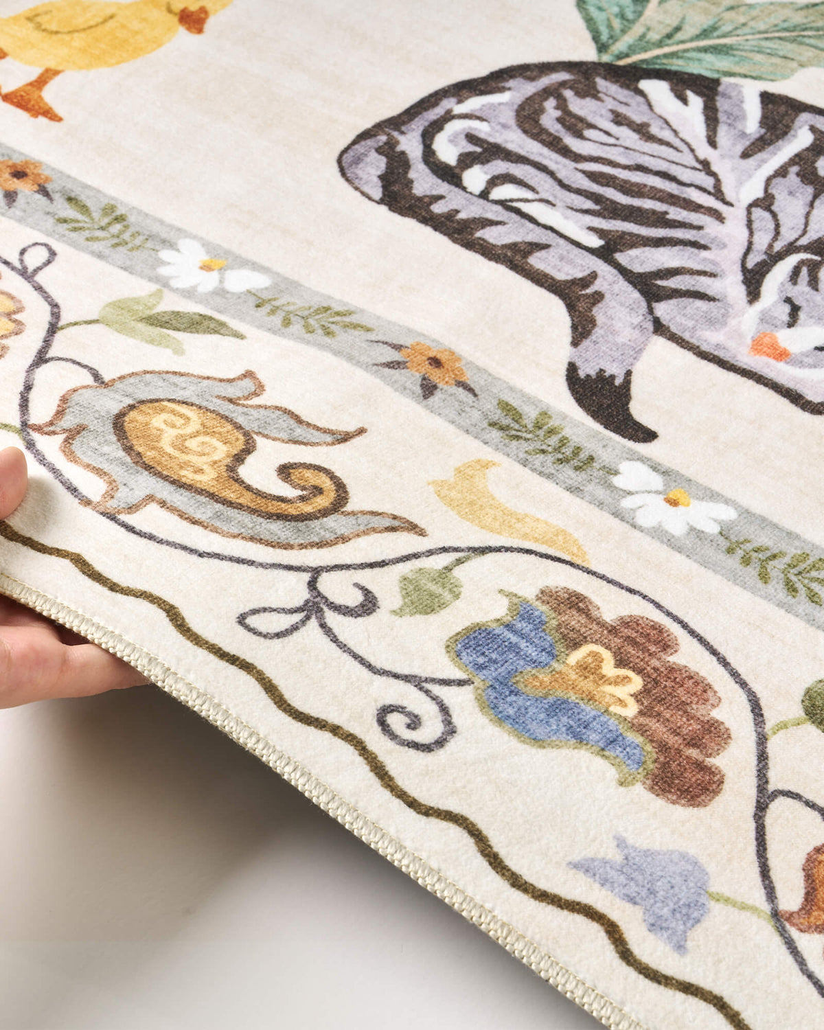 A close-up view of an ivory soft kids rug highlights its cute zebra, duck, and floral border details, along with a gentle bound edge and comfortable surface for nurseries, playrooms, and children’s bedrooms.