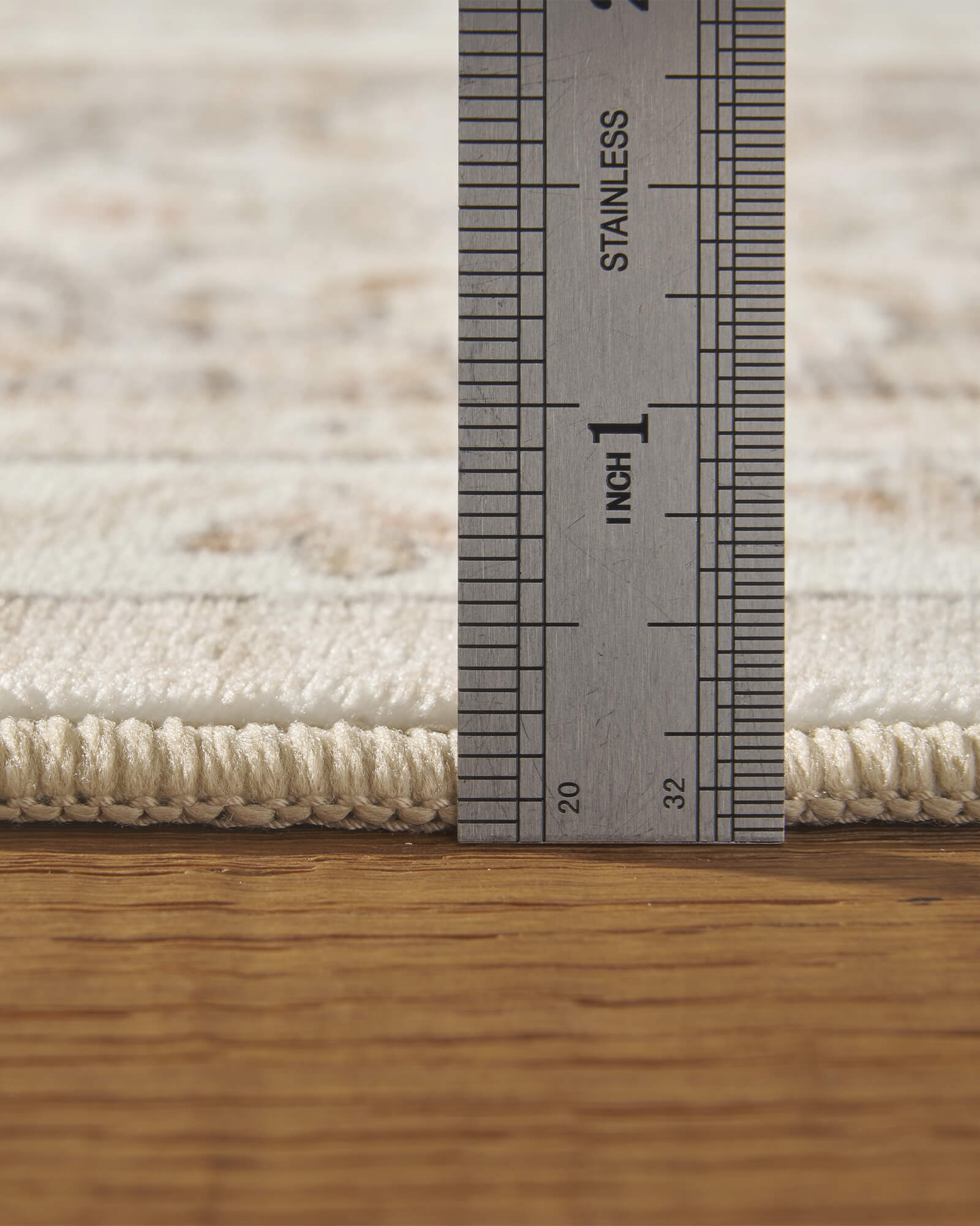 A close-up view of an ivory vintage washable area rug showing its low-profile pile height, soft surface, and bound edge detail for easy placement in bedrooms, living rooms, and everyday family spaces.