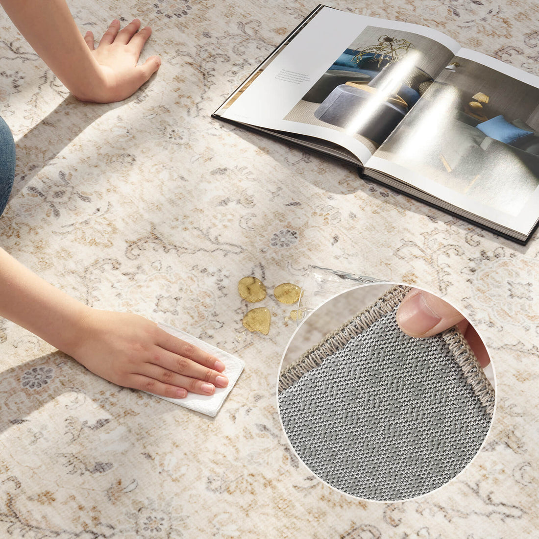 An ivory vintage washable rug is shown during a spill cleanup demo, highlighting its easy-clean surface, soft faded floral pattern, and textured backing detail for busy family homes.