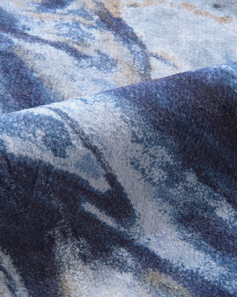 Modern rug with asymmetrical shapes and artistic marble pattern for unique home interiors.