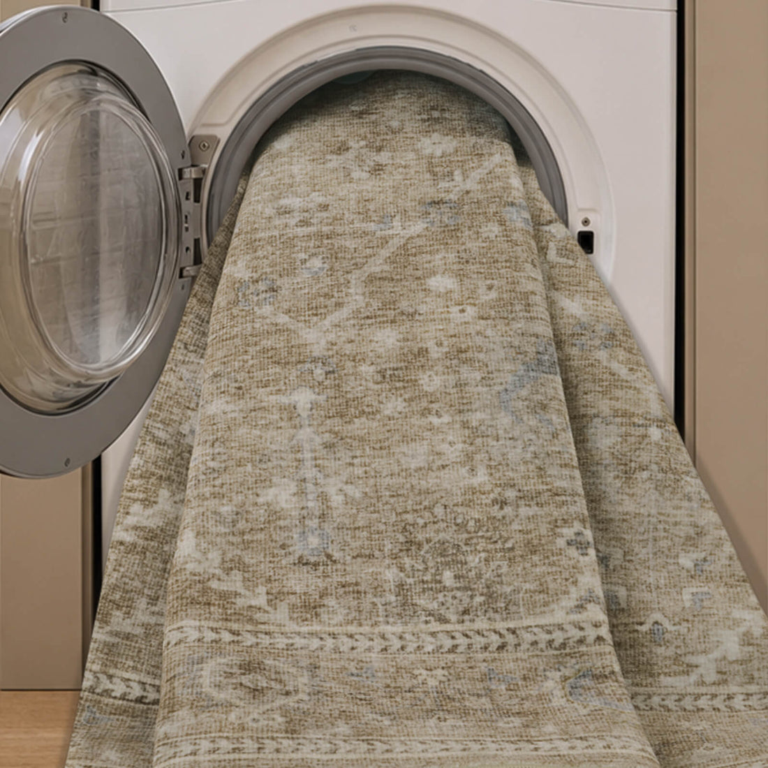 A neutral vintage washable area rug is shown in a washing machine, highlighting its easy-clean design, soft low-pile texture, distressed border pattern, and practical style for busy homes.