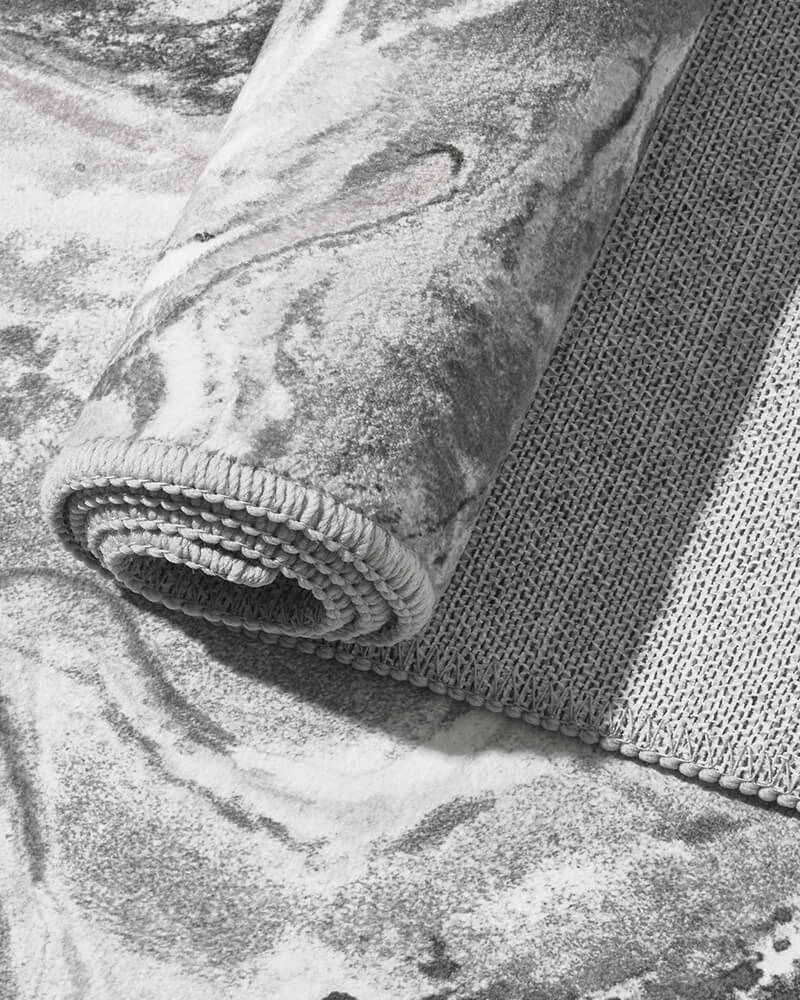 Close view of non-slip backing on modern area rug for secure placement