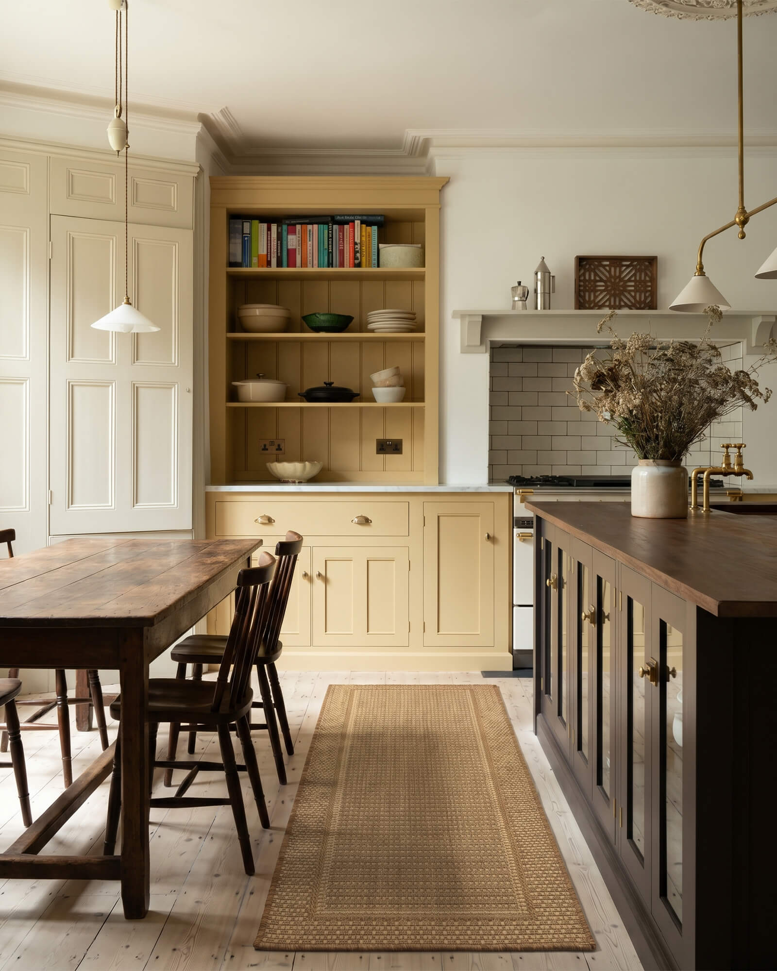 A natural woven indoor outdoor runner rug adds durable jute-look texture and easy-care style to a rustic kitchen with warm wood tones, cream cabinets, and classic home decor.