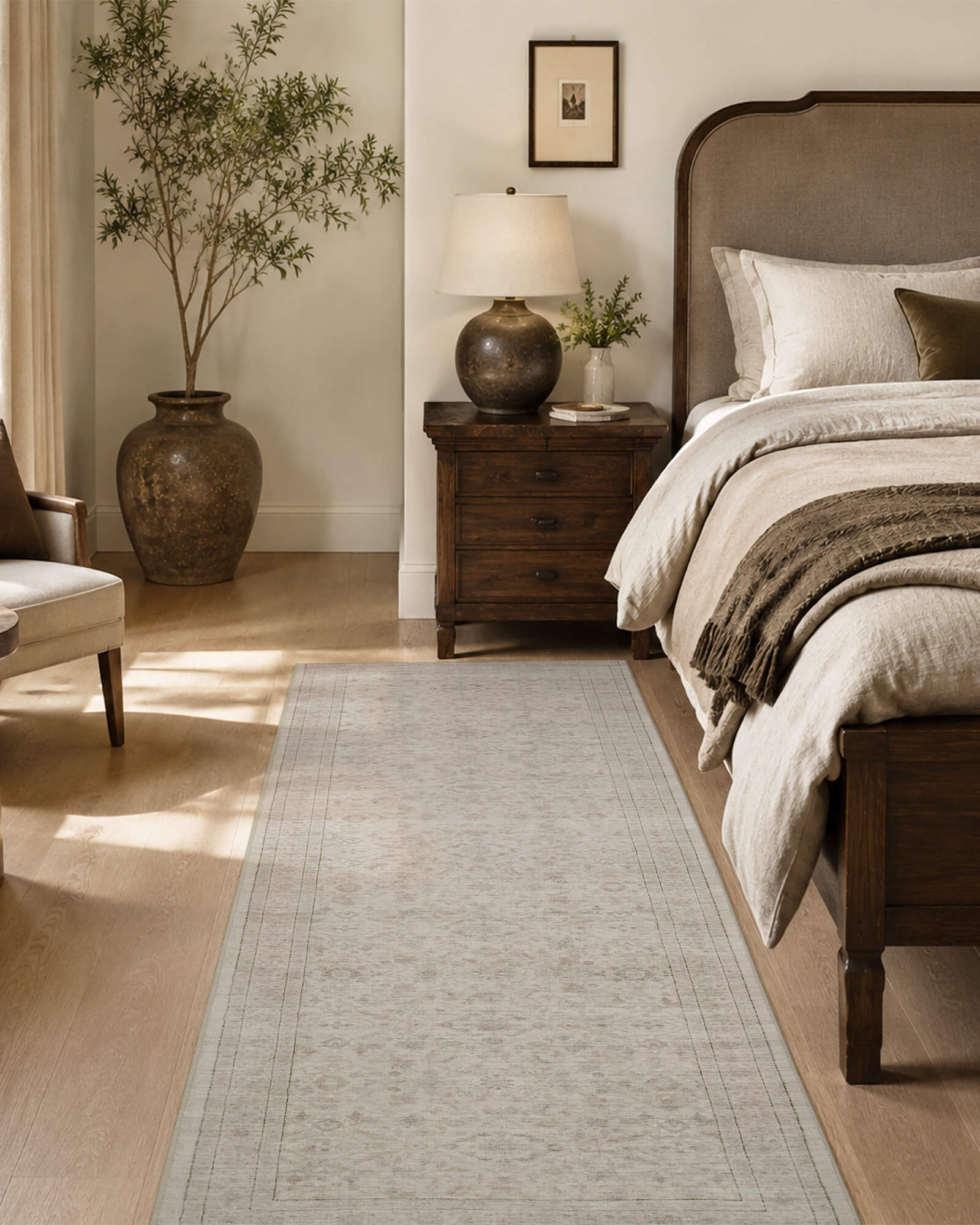 A neutral vintage washable runner rug with a soft distressed border pattern adds understated warmth beside a bed, complementing wood furniture, cozy bedding, natural light, and timeless bedroom decor.