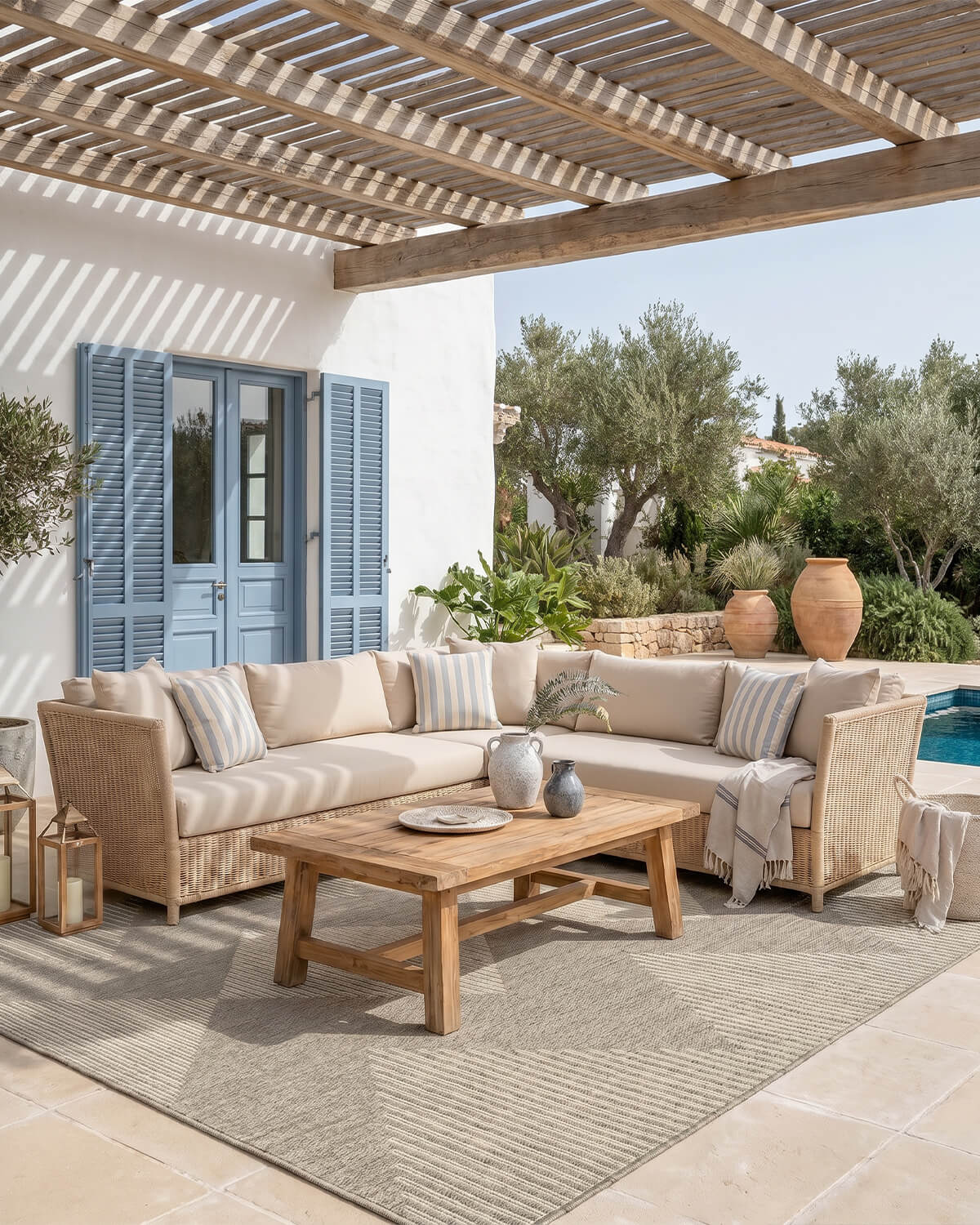 This outdoor rug adds a clean and welcoming foundation to a covered patio lounge with a durable easy-clean surface made for relaxed everyday outdoor living.