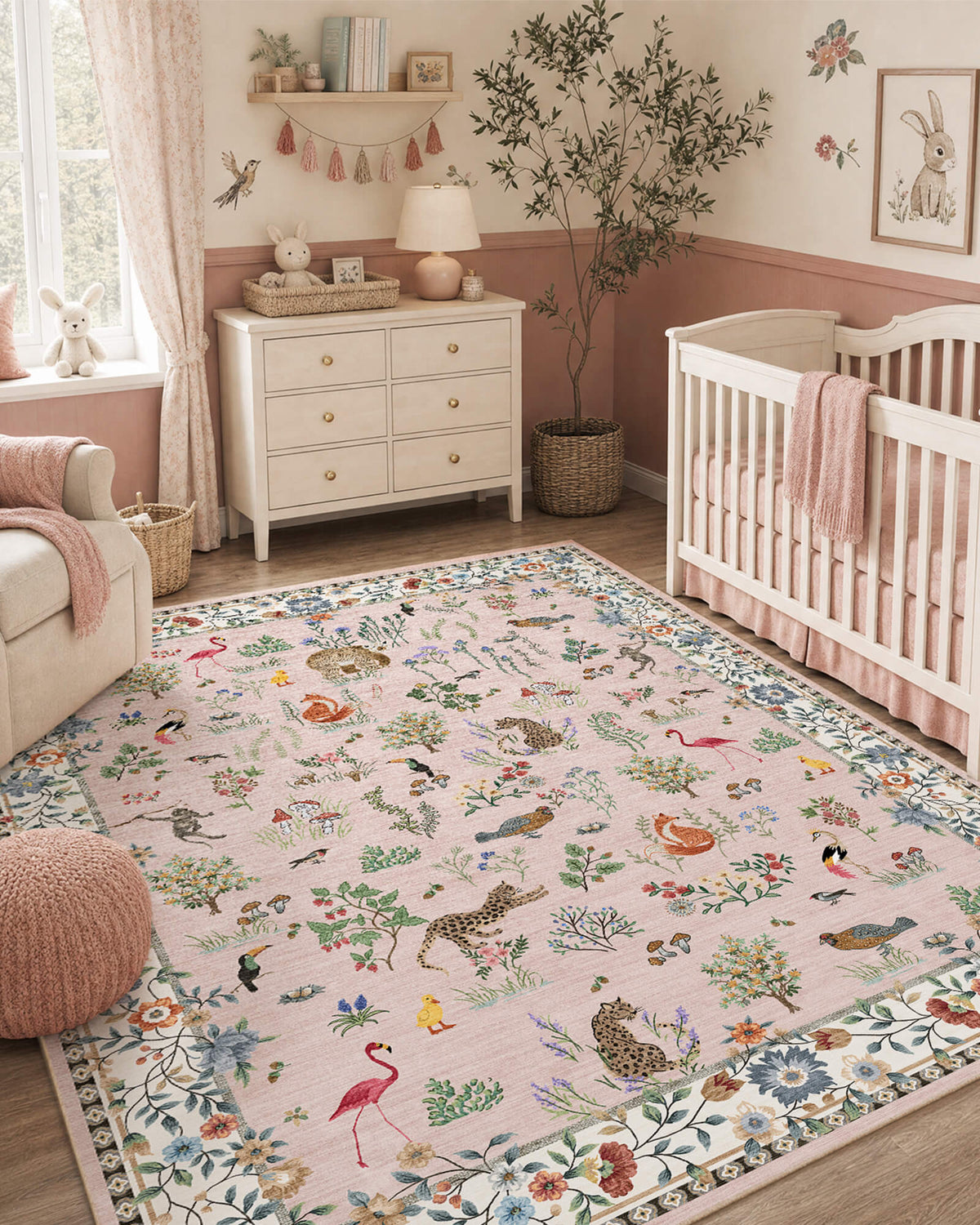 A pink soft kids nursery rug with cute forest animals, birds, flamingos, mushrooms, and floral border details creates a gentle, comfortable play space for a baby room with a crib, dresser, bunny wall art, and warm child-friendly decor.