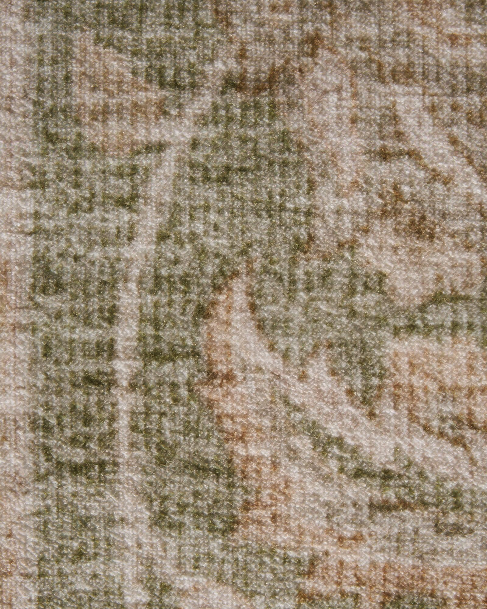 A close-up view of a sage green vintage washable rug highlights its antique faded floral texture, soft low-pile surface, and muted earthy tones for cozy living rooms, bedrooms, and everyday home decor.