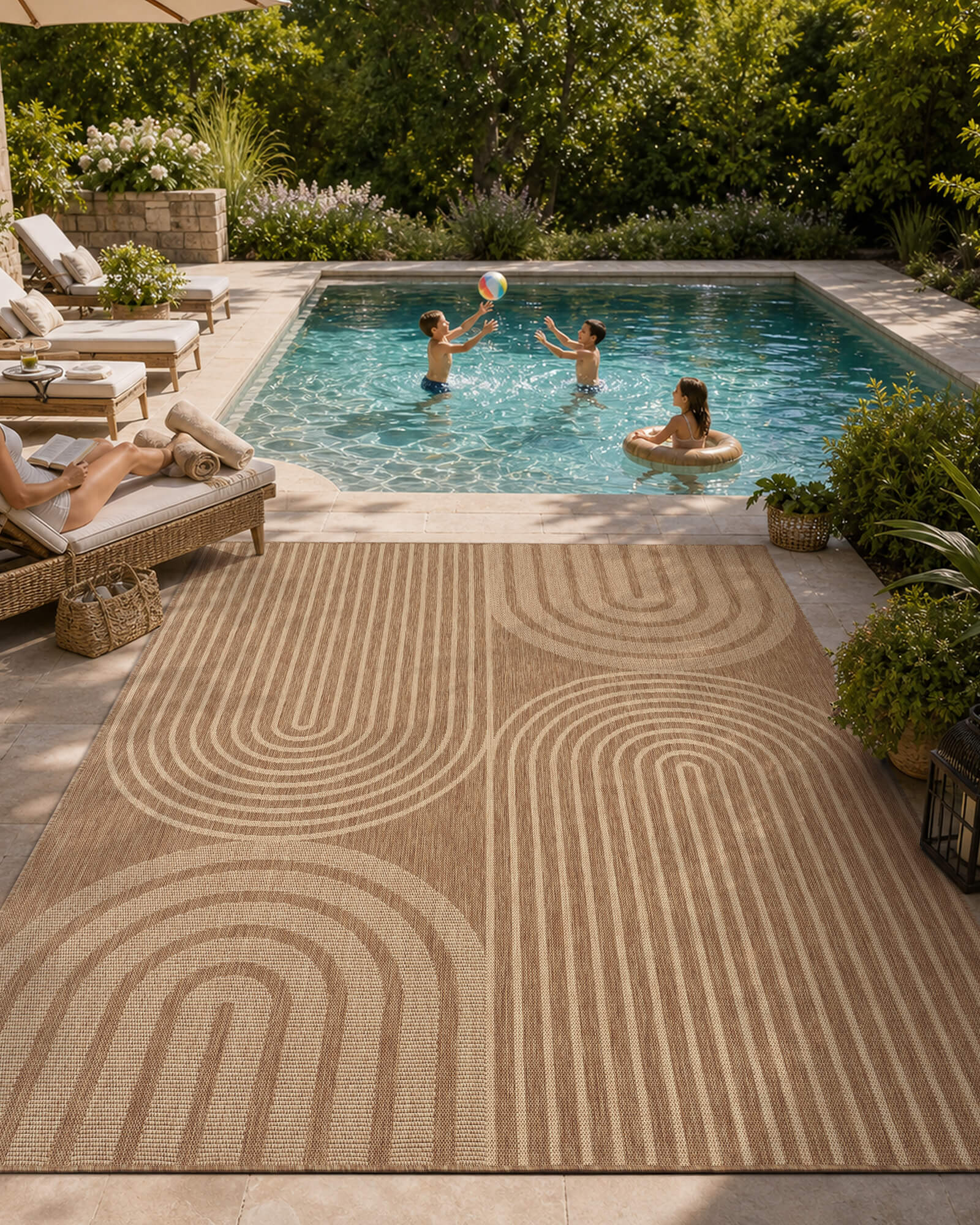 A tan abstract outdoor rug with a geometric arch pattern adds modern texture to a poolside patio, creating a stylish weather-resistant space for family lounging, outdoor play, and summer entertaining.