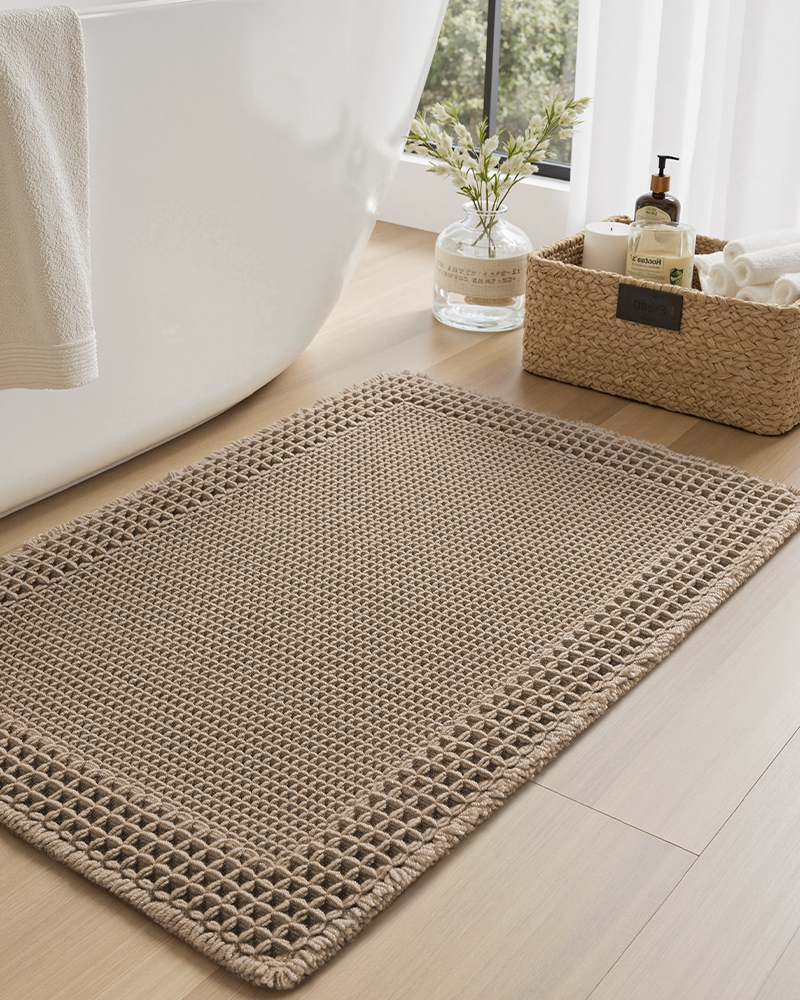 Decorative waffle bath mat, soft and super absorbent, enhances bathroom décor.