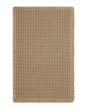 Waffle texture bath mat with decorative tassels, designed to absorb moisture quickly while adding warmth to bathroom décor