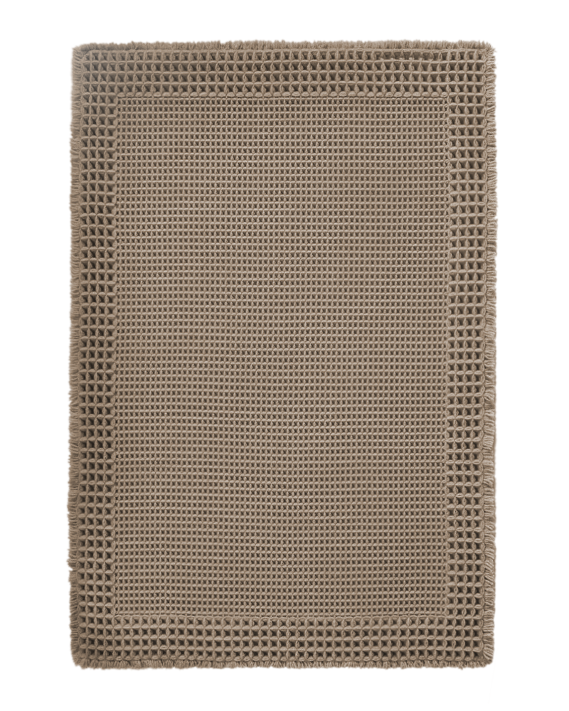 Waffle textured bath mat with absorbent surface that keeps bathroom floors dry and fresh