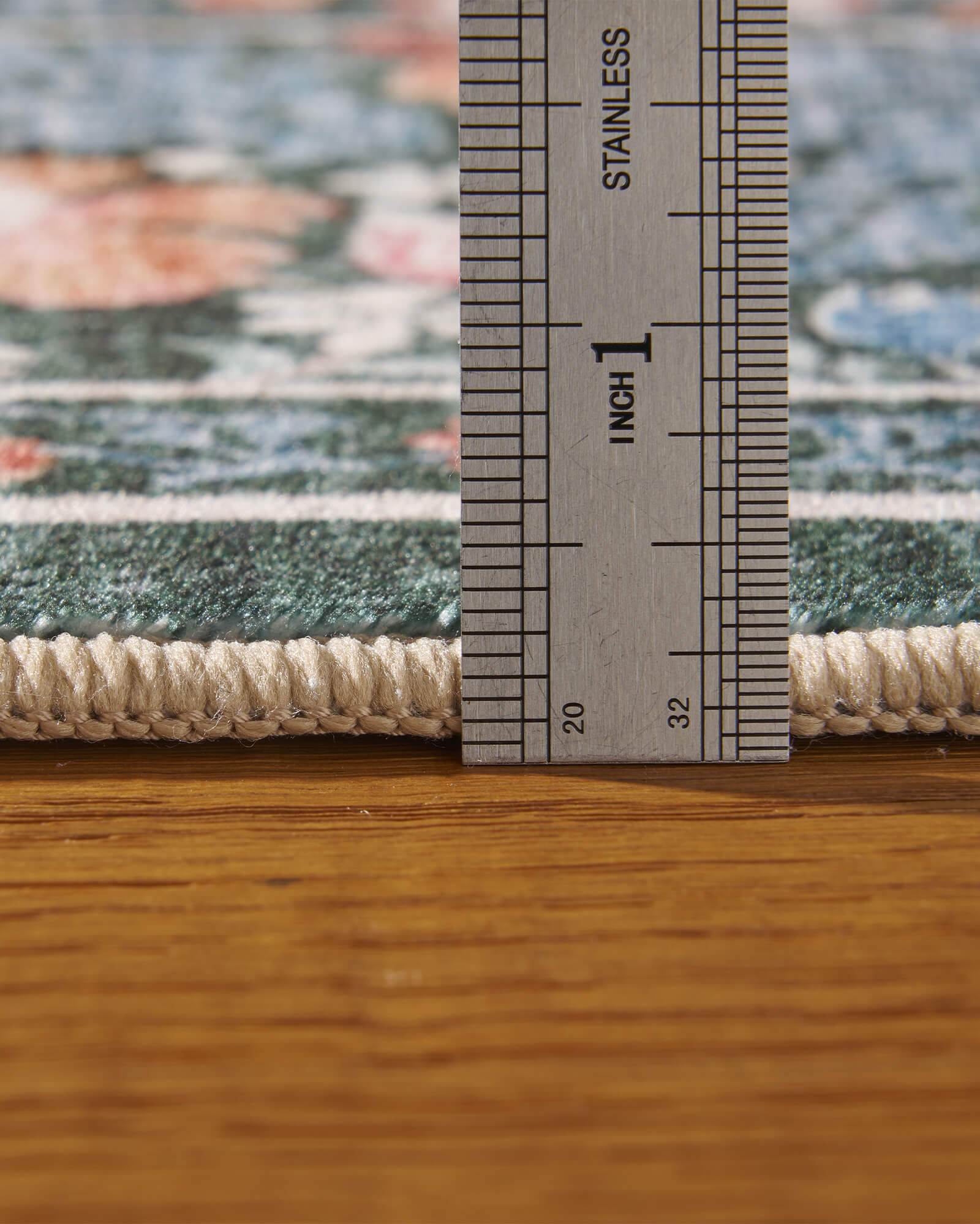 A close-up view of a washable vintage floral area rug showing its soft low-pile texture, plush surface thickness, finished edges, and durable construction designed for everyday comfort and easy care.