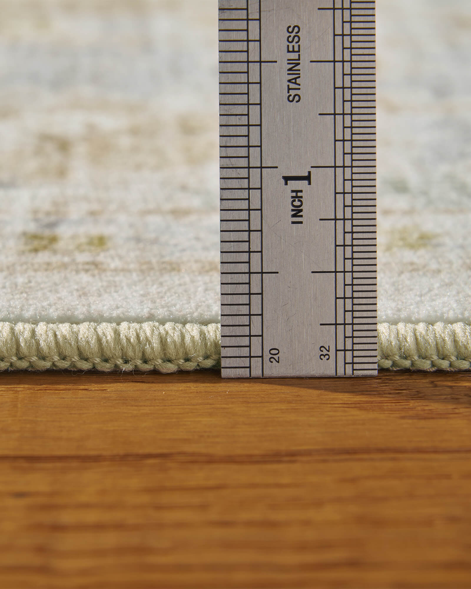 A close-up view of a washable vintage floral area rug showing its soft low-pile texture, plush surface thickness, and durable construction designed for comfortable everyday living.