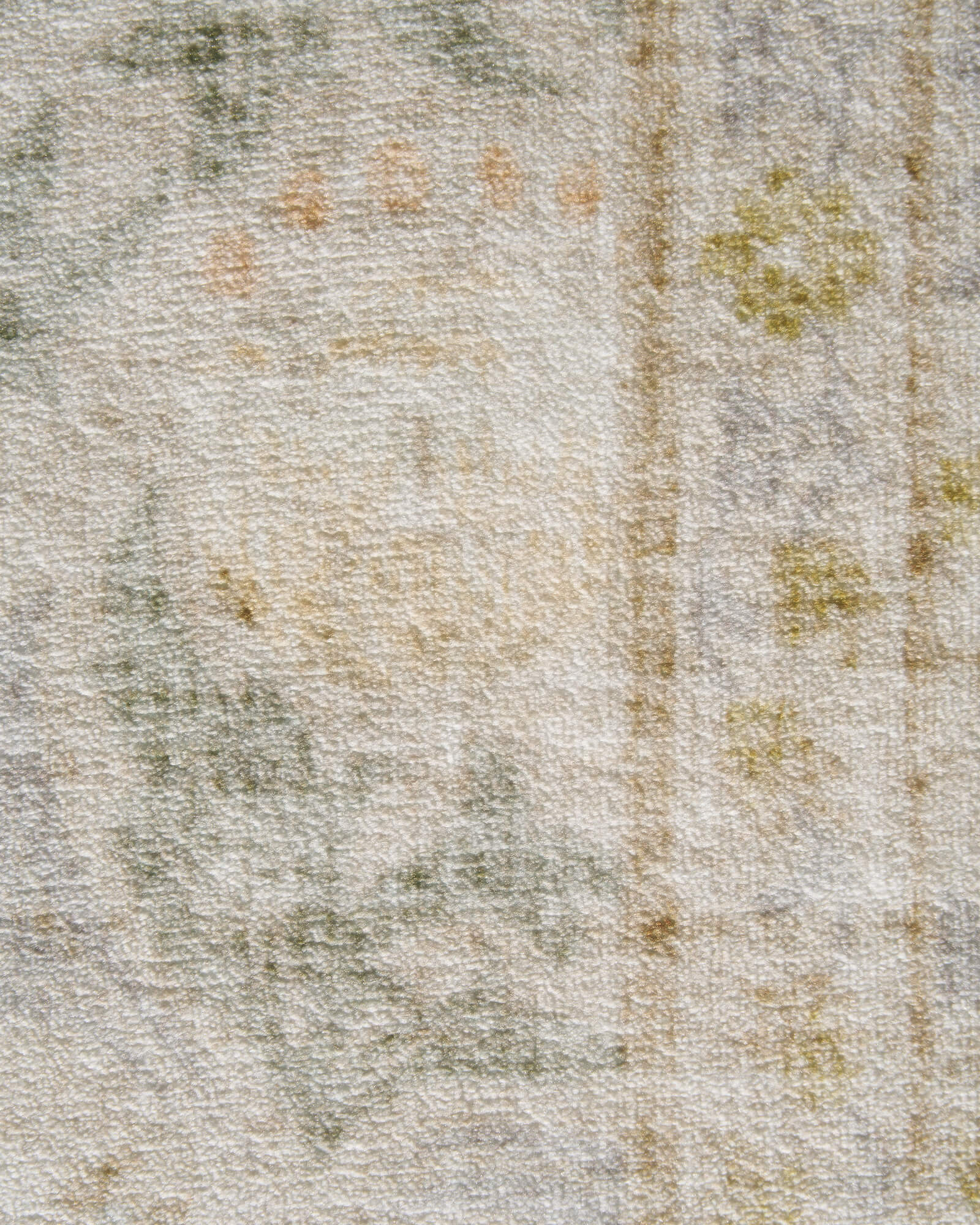 A close-up view of a washable vintage floral area rug featuring a soft textured surface, subtle botanical details, and a neutral design that complements cozy living rooms, bedrooms, and everyday home spaces.